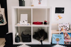 Montessori children's playroom with child size cleaning materials and low bookshelf of books with covers facing forward