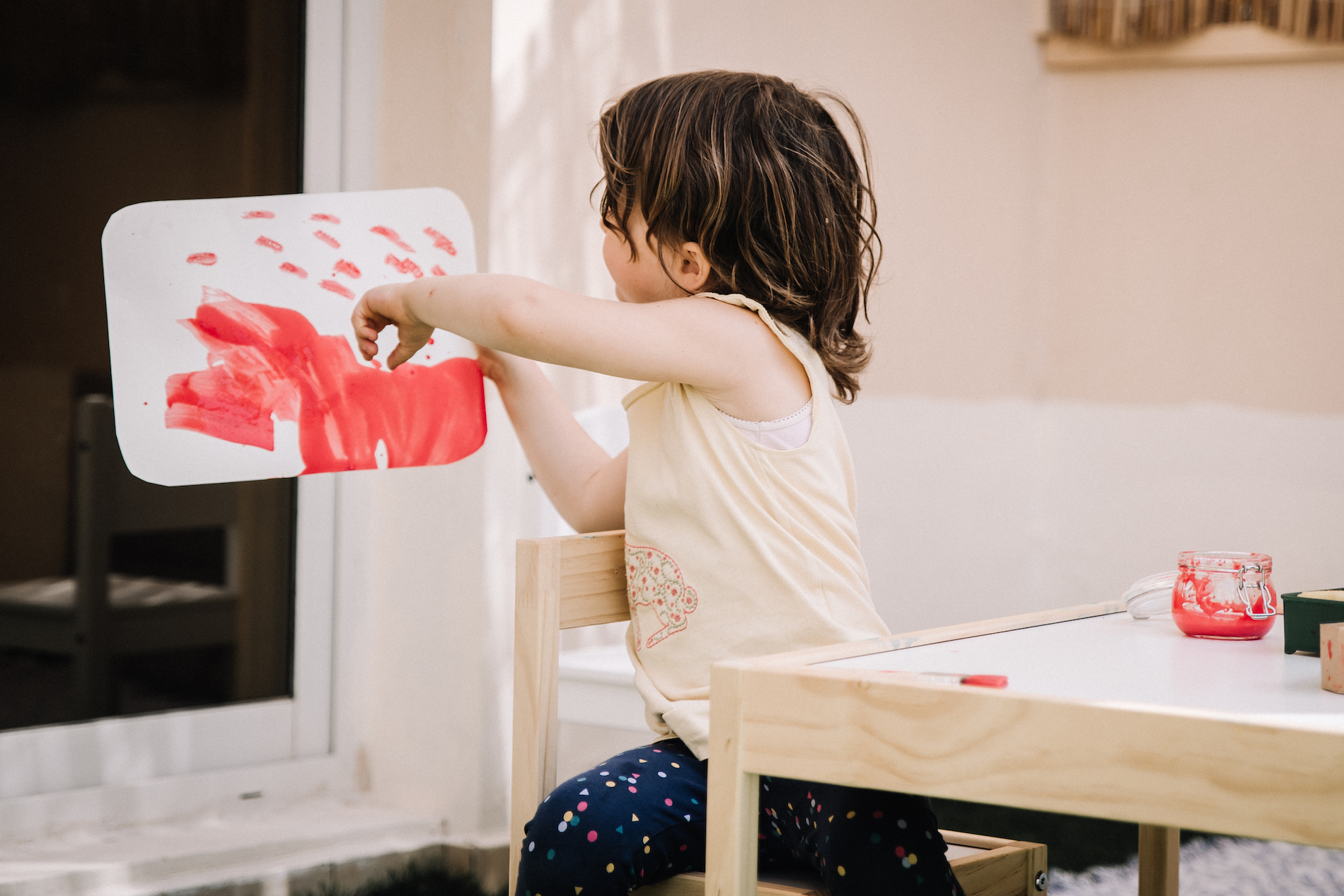 Three year old showing picture she has painted